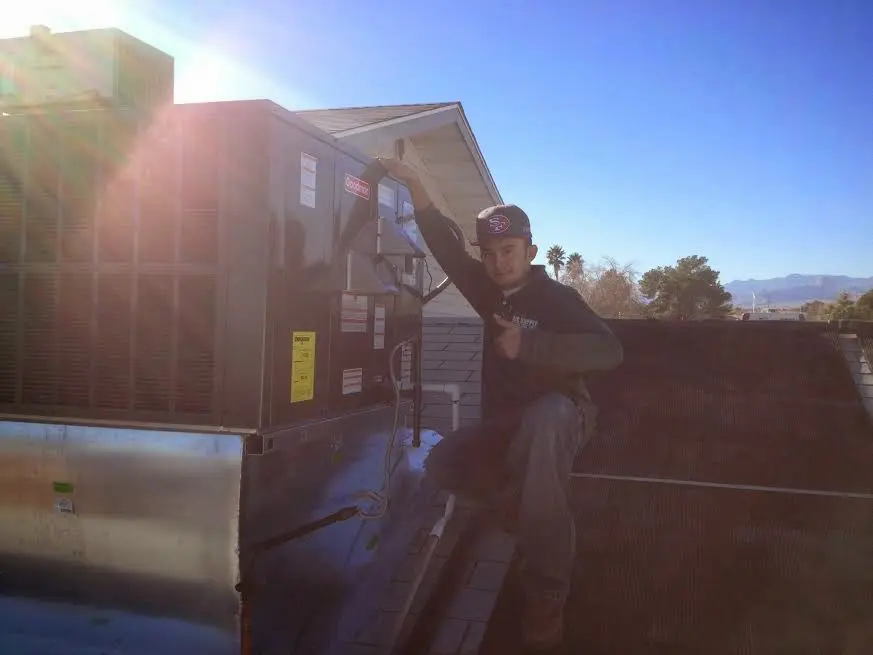 HVAC technician performing HVAC Inspection on a rooftop unit in Brainerd
